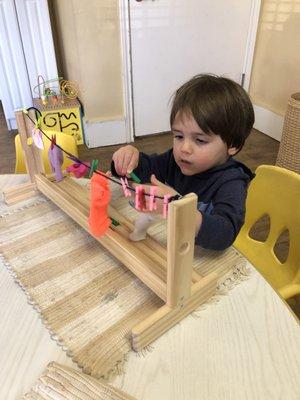 Toddler clothes pin activity to strengthen pincer grip in fingers