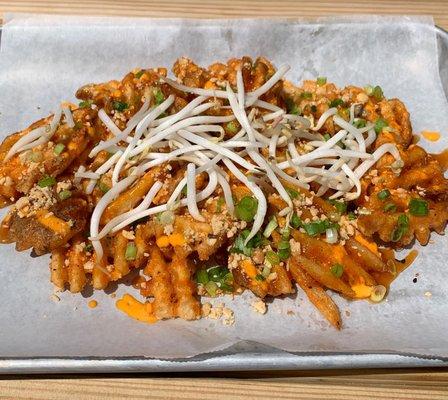 Pad Thai waffle fries with tamarind, sprouts, scallion, and peanuts