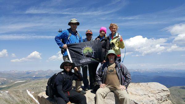 Our Axistence Athletes are big fans of taking the flag to the top of Colorado's 14'ers