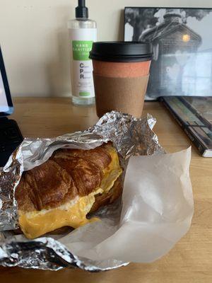 Sausage egg cheese on croissant with dirty chai