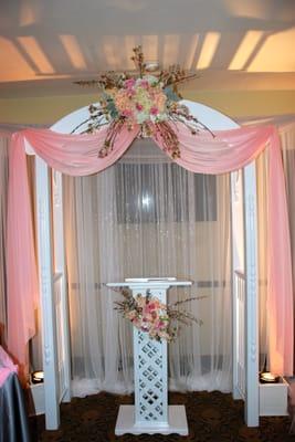 Our pipe and drape,hanging crystals, and White wood arbor give indoor ceremonies or cake displays a romantic touch!