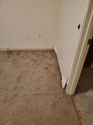 Master bedroom, no baseboard and paint peeling off walls