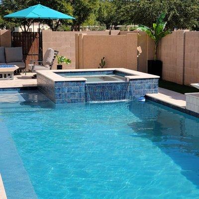 Spa with spillway flowing into the pool