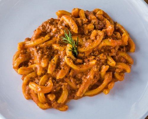 Trofie Salsiccia 
homemade pasta, imported crumbled Italian sausage, rosemary, parmigiano Reggiano, light cream tomato sauce.