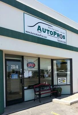 The store front view of Aurora AutoPros, complete with a fun bench out front, too!