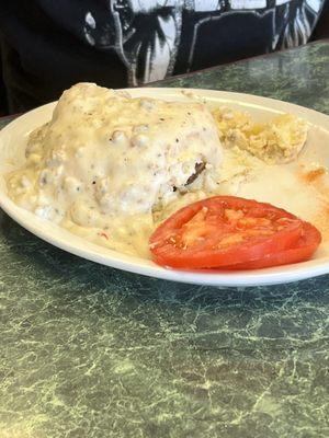 Sausage biscuit with gravy and tomatoes