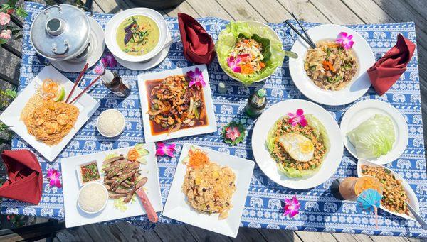 Big Table on our Patio filled with our Thai Food and Drinks