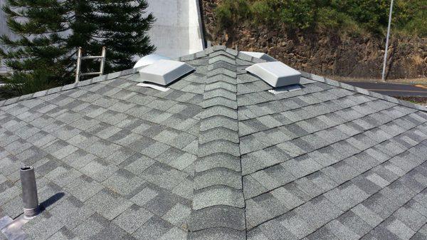 Full Reroof with four static vents at the highest peak of a three story reroof to help with ventilation of attic space.