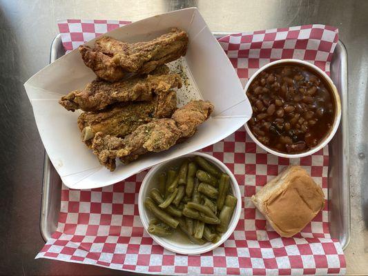 Fried wings with green beans and baked beans.