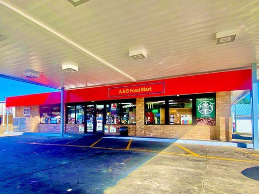 "A & B Food Mart" sells hot food. Has a hot foods deli inside.