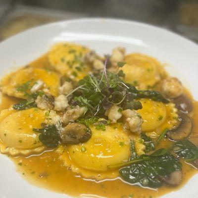 Lobster ravioli , cremini mushrooms spinach , lobster sauce