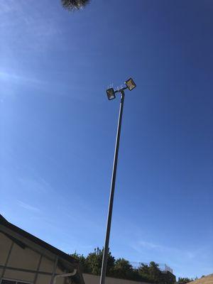 lighting for a backyard horse arena. Installation of permanent bird spikes included.