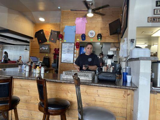 Instead of rolling silverware on the counter, how about creating a booth where guests can talk to the staff while eating single?