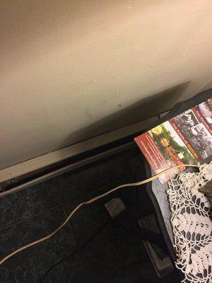 Dirty walls. Non Working baseboard heater sleeve. That wire leads to a $39.00 heater that heated nothing due to bad windows. I burned my leg