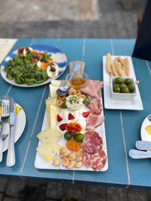 Meat and cheese, olive Grissini and caprese salad