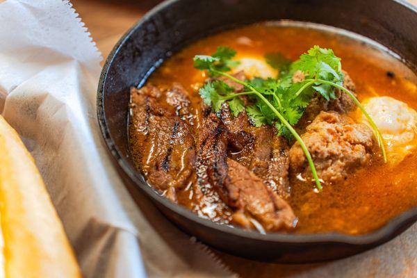 Close-up of succulent, flavorful beef soaking in a rich broth--this will warm your soul.