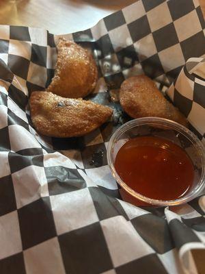 Duck wontons with Asian chili sauce. (After we dig in!)