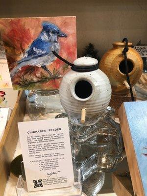 Original artwork by Michael Cade with handmade chickadee feeders made in Burnsville, NC. We love our local artisans!