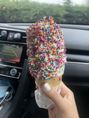 Soft serve vanilla with rainbow sprinkles