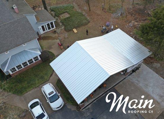 Metal roof installation on car port.