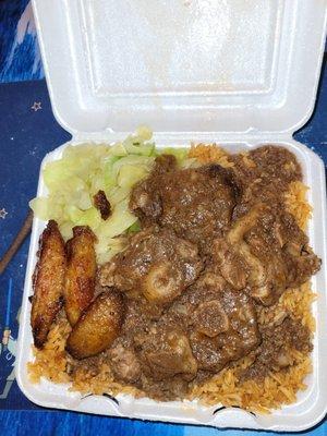 Oxtail and stew with cabbage, plantains and jolloff rice