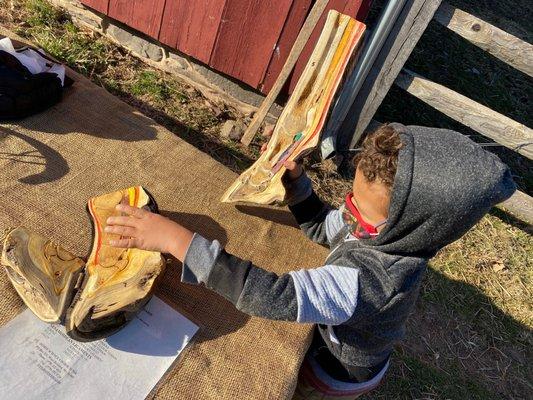 Child looking at an educational display about a horse's leg