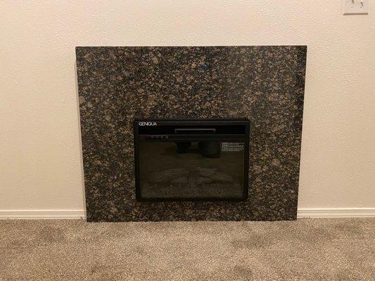 Simple granite fireplace surround