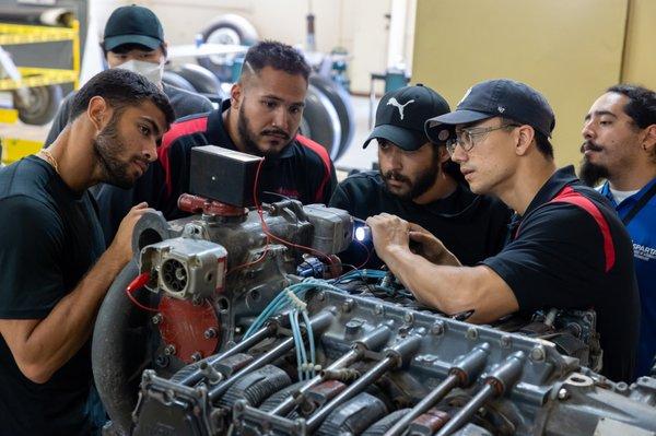 Aviation Maintenance students working on an engine