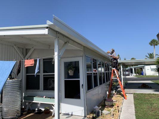 The new gutter being installed