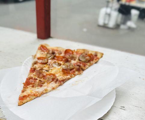 Meat lovers slice, truly thin, bottom is crispy, the perfect slice of what New York pizza oughta be!