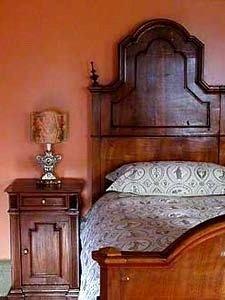 Luigi  Filippo Room, with Frette bed linens, Fortuny lampshade, and  19th-century walnut furniture