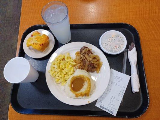 Corn bread, chopped steak w onions, mashed potatoes w gravy and peanut salad.