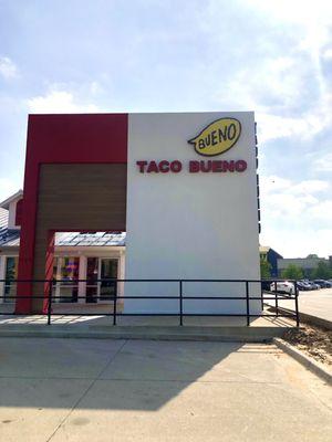 Front of Bueno (faces east); drive thru on the right.