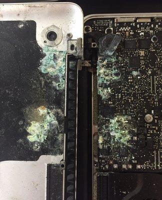 Example of extreme corrosion on a main logicboard (MLB). This is can happen when liquid makes contact with an active circuit board.