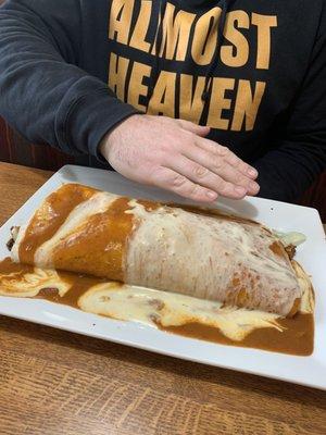 Hand to show how massive the California burrito is.