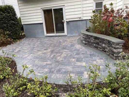 Patio with stone wall and pavers