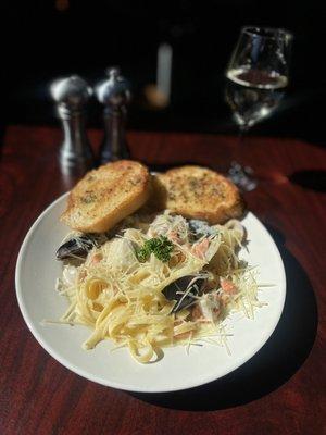 Seafood Alfredo medley with mussels, salmon, cod, rockfish, baby scallops and clams