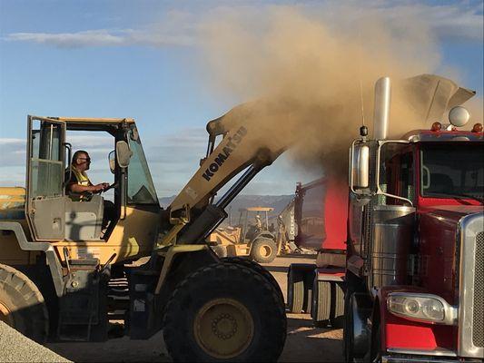 Crews loading material into a truck