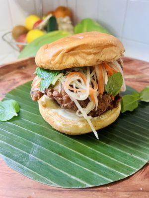 Cambodian Chicken Sandwich. Marinated in Kreung (lemongrass paste) deep fried with rice flour (gluten free), topped with pickled papaya