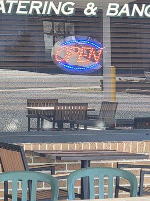 Open sign on a closed restaurant