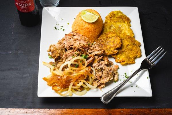 Classic Lechón Asado (Roast Pork) with our Cuban Mojo, plantains and yellow rice.