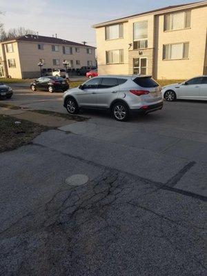 The cars blocking the entrance to the next lot