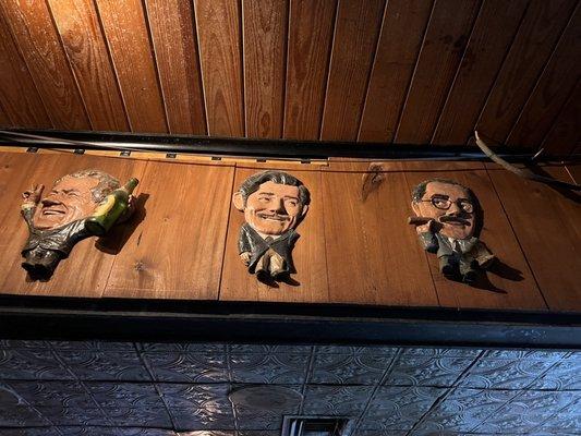 There are so many wooden caricatures of famous people that line the walls!