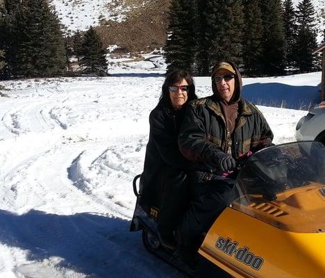 we love our snowmobile - riding in front of cabin at UV Red River.