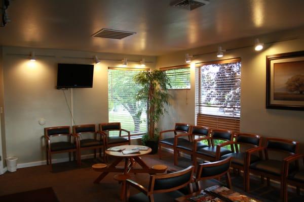 Waiting room with comfortable chairs, current magazines, activities for children, and a TV.