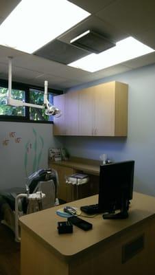 One of the exam chairs and ceiling tv.