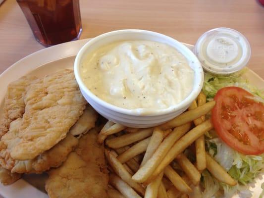 Wholly bowl of gravy and a side of a chicken strip meal.