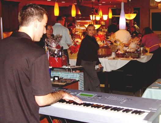 Keenan Baxter performing during Cocktail Hour Smooth Jazz at a Fundraiser at Service Doctor!