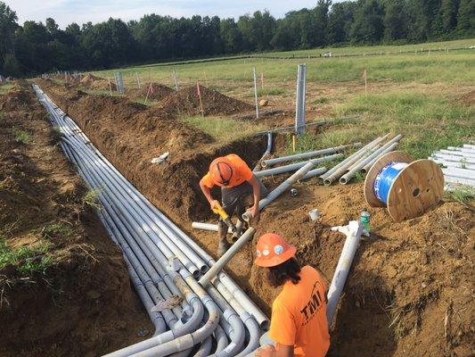 Ray and Tony cutting and installing conduit for a solar array in Brewster, OH.