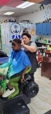 My other grandson getting his hair cut